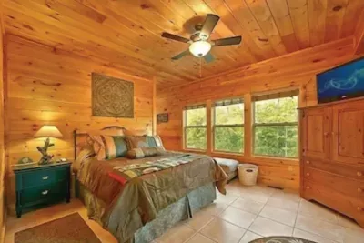 Master Suite #2 on 1st floor. Queen bed, Dish TV, full bathroom, + deck access.