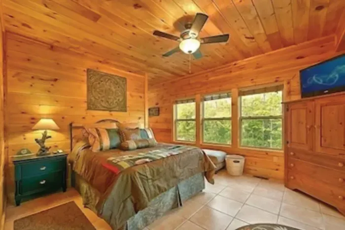 Master Suite #2 on 1st floor. Queen bed, Dish TV, full bathroom, + deck access.