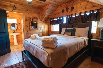 Master Suite #4 on 2nd floor with queen sized bed. Full bathroom attached. Full sized leather futon on the right side of this bedroom for additional sleeping space.