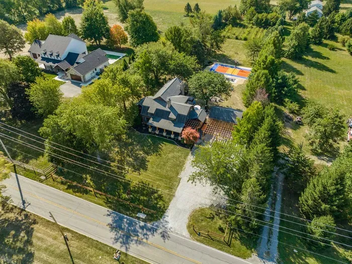 Aerial view of the property featuring the front yard, located in a peaceful neighborhood