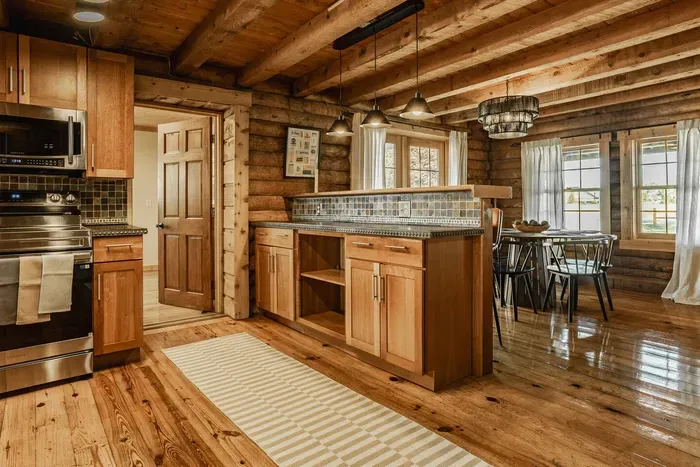 open kitchen leading into a bright dining space, blending rustic charm with modern comfort and effortless flow.