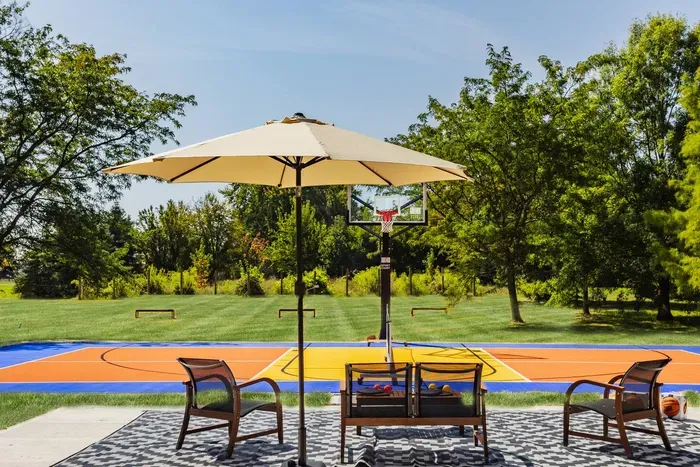 Enjoy a vibrant outdoor basketball court with comfortable shaded seating — perfect for friendly games and relaxing under the sun.