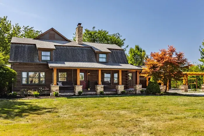 Front patio with a welcoming porch and a detached garage on the side.