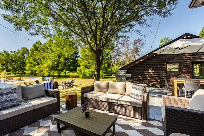 Lounging area that offers a peaceful ambiance under the shade of trees, surrounded by lush greenery—perfect for unwinding.