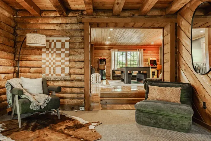 Inviting lounge area with warm soft seating that opens up to a spacious game room filled with natural light.