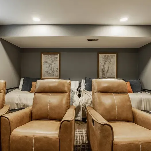 Kick back and relax, and enjoy a fun movie night in this home theater, complete with reclining leather chairs and daybeds.