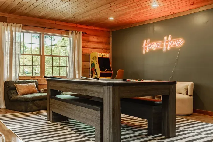 Enjoy a game on the modern pool table set in a warm, inviting ambiance.