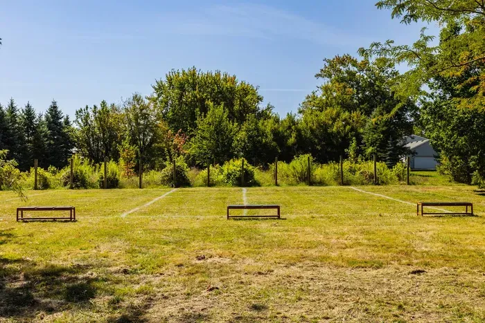Expansive open yard featuring a simple outdoor game setup.