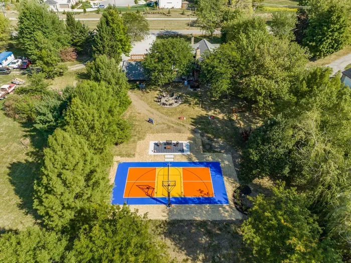 Aerial view of the spacious backyard with the outdoor basketball court 
