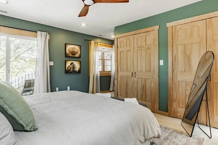 Featuring spacious wooden closets and direct access to a private balcony for fresh air and natural light.