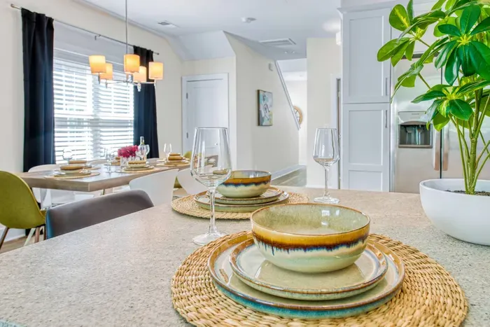 Bright and inviting kitchen bar counter set for dining — the perfect spot to enjoy a relaxed meal or morning coffee while overlooking the open dining area.