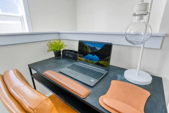 Workspace with natural light, comfortable seating, and a sleek desk setup — perfect for remote work or study.