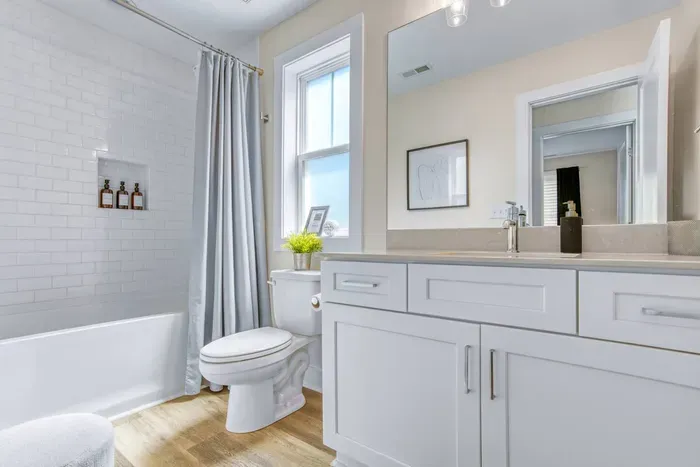 Stylish full bathroom featuring a bright, clean design with a shower-tub combo and modern finishes.