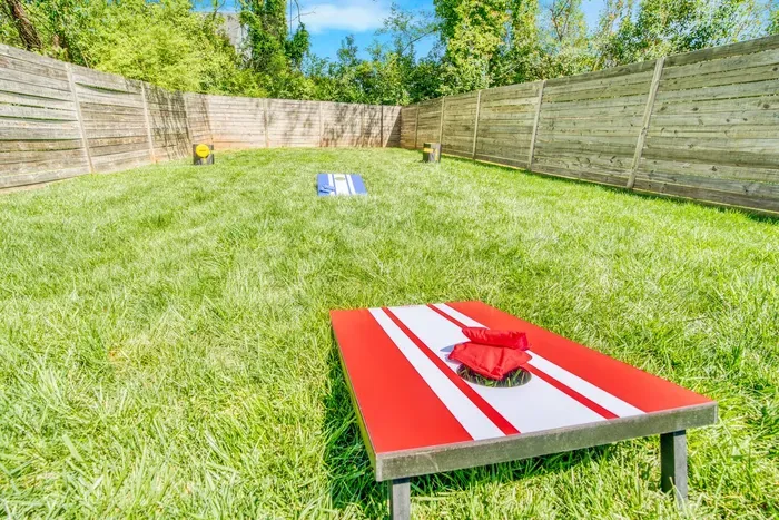 Featuring a cornhole setup