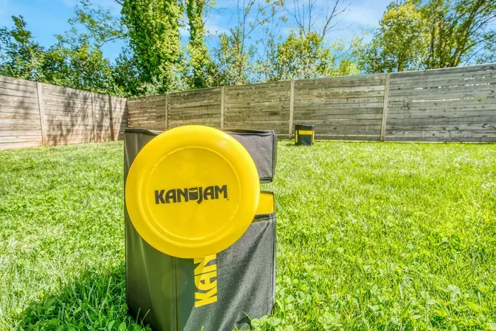 Spacious fenced backyard with lawn games — perfect for outdoor fun and relaxation.