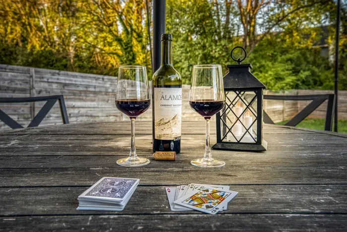 Backyard patio with outdoor dining, umbrella shade, and a grill — ideal for barbecues and relaxing outdoors.