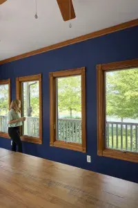Bright sunroom with lakeview windows, vaulted ceiling, warm wood accents.