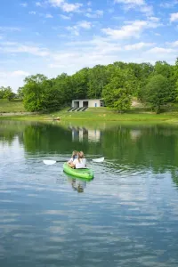 Serene lakefront escape with kayaks, boathouse, and peaceful forest views