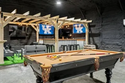 Pool Table next to custom sports bar with flatscreen TV's