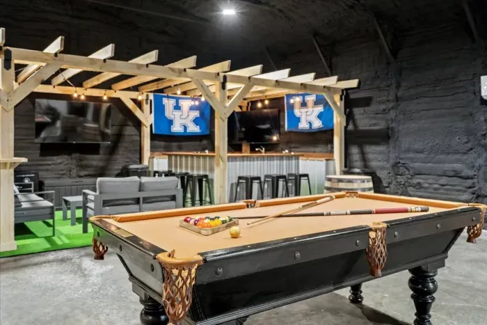 Pool Table next to custom sports bar with flatscreen TV's