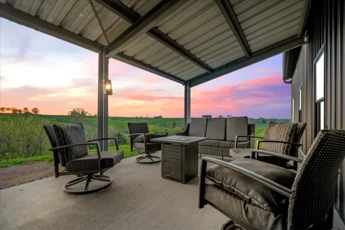 Back patio with beautiful views of bluegrass country hills and a lounge area next to the Weber Grill 
