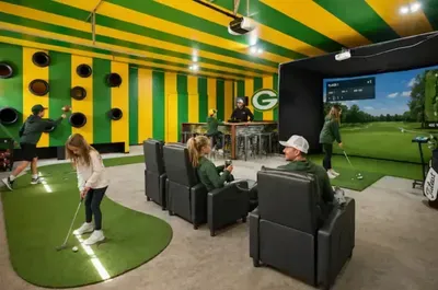 Group playing the golf simulator at the Merrimac Wisconsin barnhouse