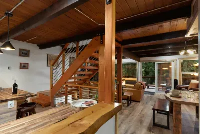 The warmth of this open-concept space is so welcoming! The wood floors, cozy furnishings, and wood stove make your stay homey and peaceful. :)