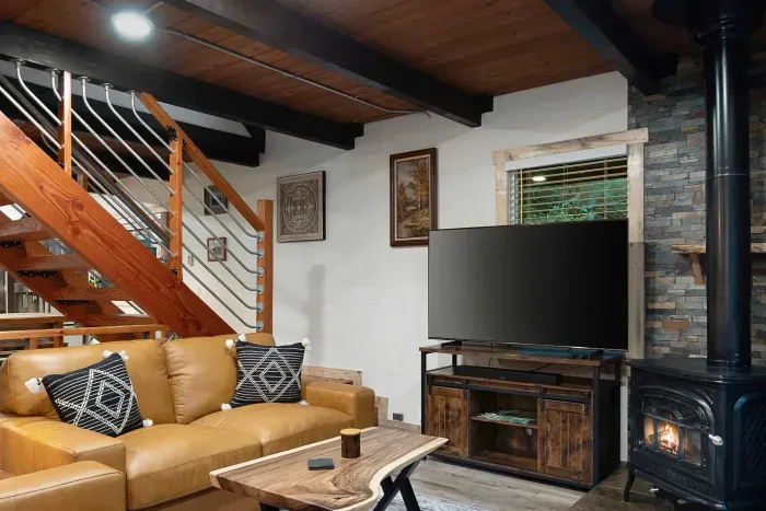 Sink into the leather couch and chair, kick your feet up, and enjoy a movie night at the cabin. :)