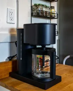 Coffee maker with fresh coffee provided.