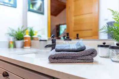 The bathroom and shower are stocked with plush towels and organic, eco-friendly bath products: hand soap, lotion, shampoo, conditioner, and body wash. 