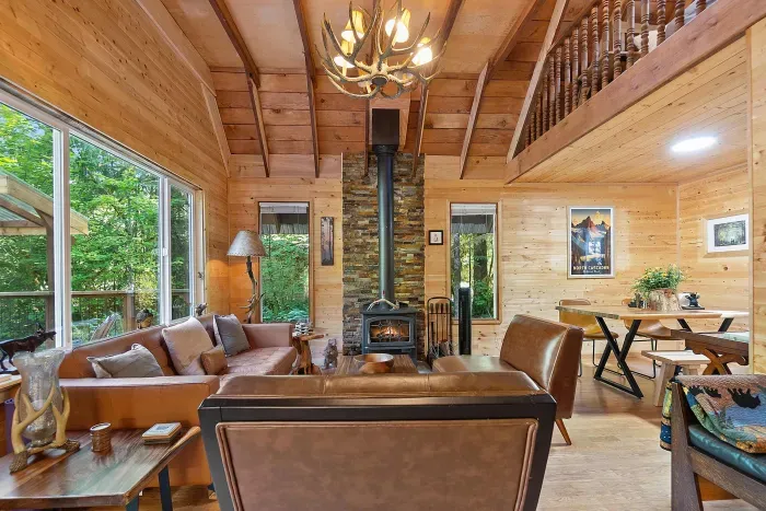 Comfy furniture, a toasty wood stove, and warm wood everywhere makes for the most relaxing environment.