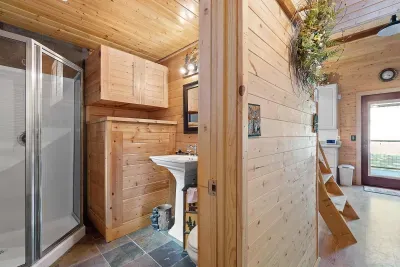 The 3/4 bath is stocked with plush towels and organic shower products. 