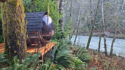 Panoramic custom barrel Sauna perched on the ridge over the river