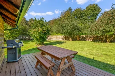 Enjoy outdoor meals at the picnic table, with the grill nearby and the lawn just beyond.