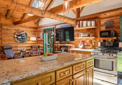 The kitchen island looks across the open living area, keeping cooking and conversation connected.