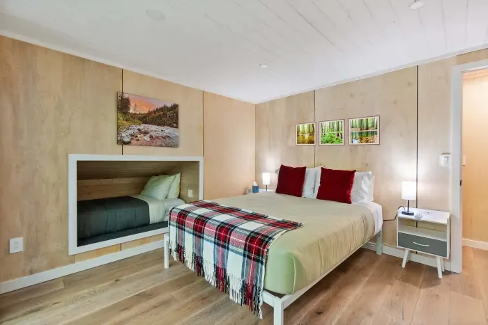 The main bedroom, located upstairs, has a plush queen bed, cozy sleeping nook, and it's own private deck overlooking the river.