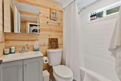 The full bath is stocked with plush towels and organic bath products.
