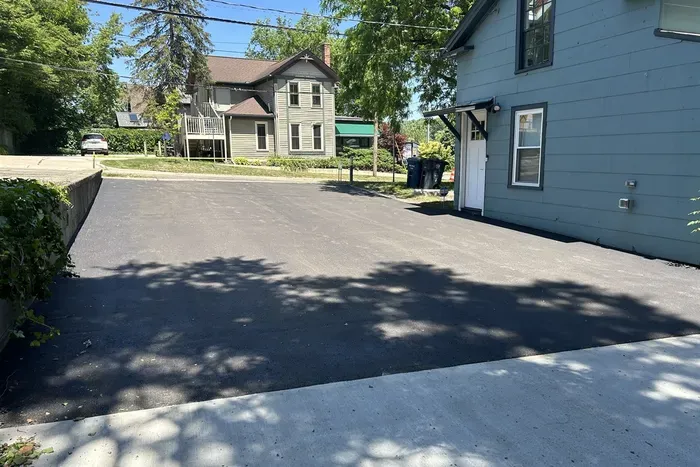 Newly paved driveway fits 4 cars, or two large SUVs