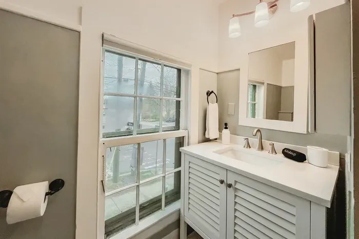 Full bathroom with towels and shower amenities