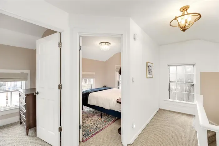 Upper hallway leads to two additional bedrooms upstairs with luxury queen mattresses for two, and a dresser and hanging hooks for your clothing