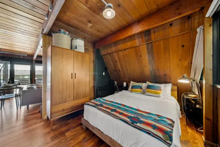 Tucked among the trees, this peaceful bedroom offers quiet mornings, soft light, and restful sleep.