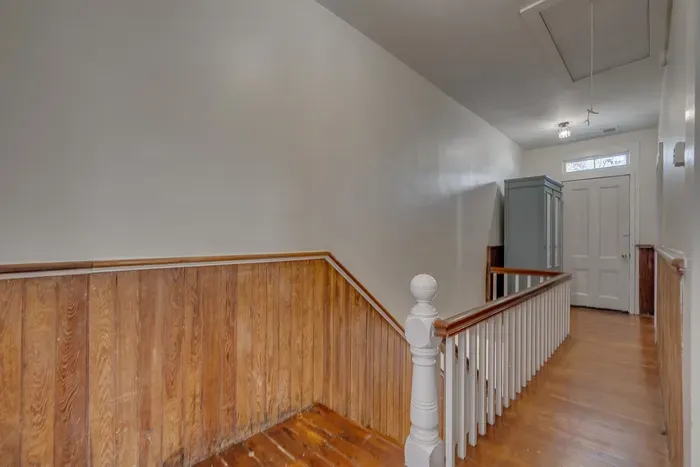 A victorian staircase that showcases the timeless beauty of Silas Fulton Historic House. You can access the balcony/upper porch from the landing.