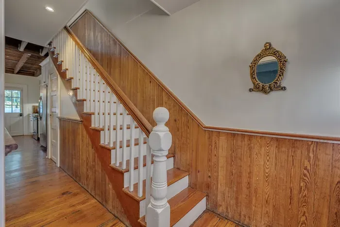 A Victorian staircase leads upstairs to the three bedrooms