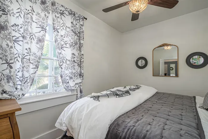 A bright and airy bedroom that combines historic character with modern comfort.
