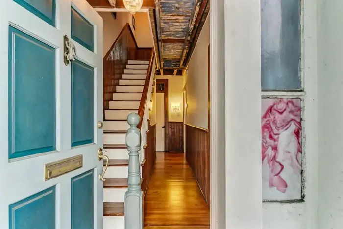 Step into history with the original Haint Blue ceiling, a centuries-old tradition believed to ward off evil spirits, welcoming you with its timeless charm.