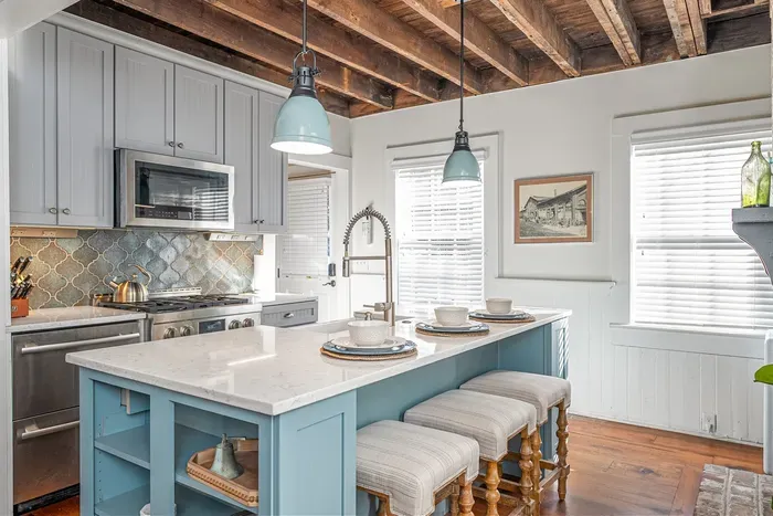 Our kitchen blends historic charm with modern comfort.While Savannah’s  fine restaurants await, you’ll find everything you need to cook right here. JennAir appliances, including a convenient drawer refrigerator to the left, make meal prep a breeze