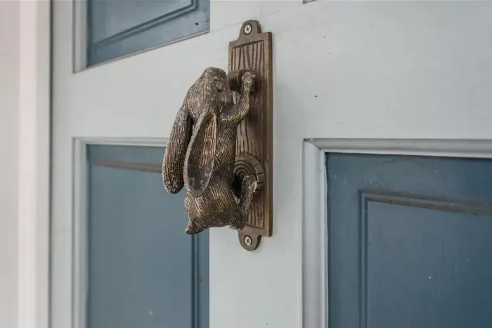Vintage front door knocker warmly welcomes visitors to your home away from home while staying in Savannah.