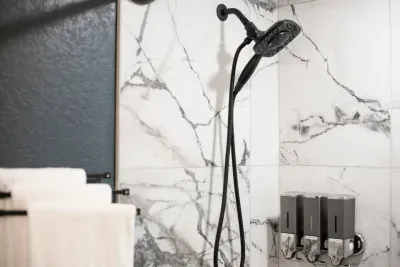 Extendable 2-in-1 shower head with 4 spray settings. Forgot your shampoo, conditioner, or body wash? We have you covered in all of our showers!