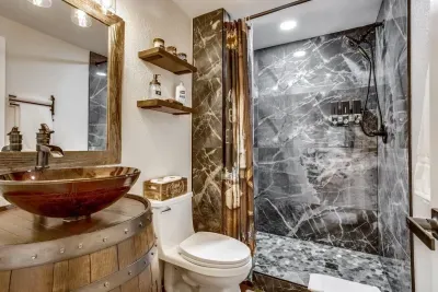 Master bathroom: Extendable 2-in-1 shower head with 4 spray settings. Custom-made whiskey barrel vanity. Italian shower tile with bench. Riverstone shower floor. Custom-built open shelves.