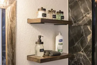 Each bathroom has a grey towel to remove makeup, cotton pads, cotton swaps, floss, and lotion for your convenience. All placed on our custom built open wood shelves.